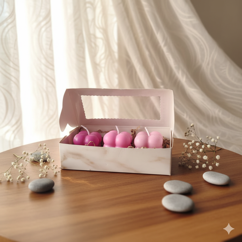A set of three pink ombre bubble candles in a luxury gift box, minimalist home decor aesthetic.