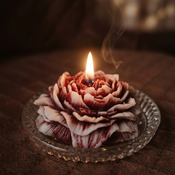 Hand-poured peony flower shaped candles in red, ivory, and multi-colour.