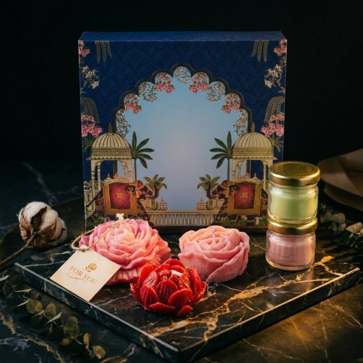 Luxury blue candle gift hamper box featuring traditional gold elephant motifs and royal Indian architecture design, standing vertically as a premium gift packaging option
