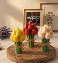 Five Tulip Bouquet in Jar candles in red, pink, purple, white, and yellow shades arranged on a marble surface with pearls.